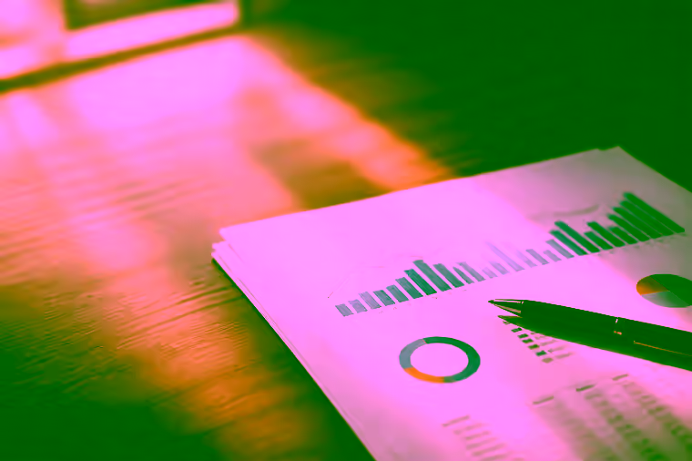 A printed search performance report with charts, a pen resting on it